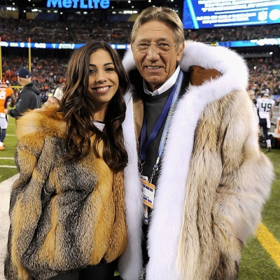 Jessie Namath with her father in a football stadium.